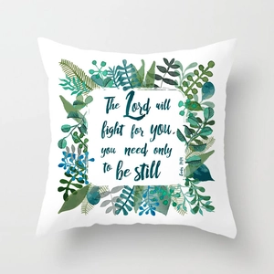 Detail of green leaf wreath cushion cover with printed blue bible verse Exodus 14:14