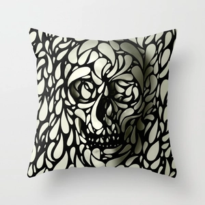 Detailed view of square linen pillowcase featuring a stylized black and white skull pattern