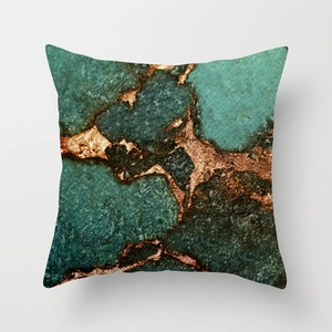 Detail of artistic teal and emerald marble texture on square peach skin cushion cover