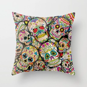 Detailed view of Mexican sugar skull patterns and vibrant floral prints on linen pillowcase