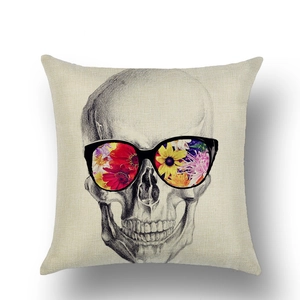 Detail of linen Halloween pillow cover featuring a skull with colorful floral sunglasses