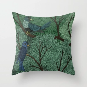 Detailed view of square cushion cover featuring birds and green botanical patterns