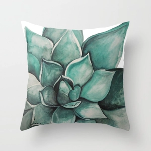 Detailed close-up of watercolor succulent patterns on a soft peach skin cushion cover