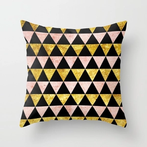 Detail of geometric peach skin cushion cover with gold and pink triangles on grey back