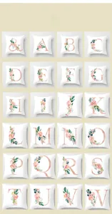 Detail of rose gold alphabet pillowcases with floral accents on white plain fabric