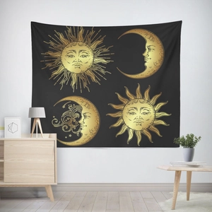 Detail of bohemian black and gold tapestry featuring sun and moon celestial designs