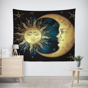 Macro detail of sun and moon tapestry with celestial astrology gold pattern on black wall