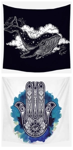 Detail of bohemian tapestry featuring whale and Hamsa hand motifs in black and white