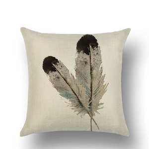 Detailed view of linen cushion cover with watercolor feather print and natural texture