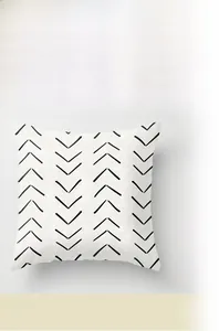 Close-up of geometric black V-pattern on high-quality white fabric cushion cover