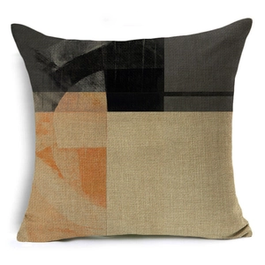 Close-up of geometric abstract cushion cover showing textured linen fabric and stitching