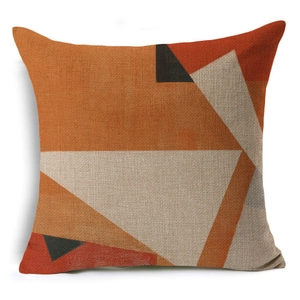 Detailed texture of geometric linen pillow cover with orange and grey triangular patterns