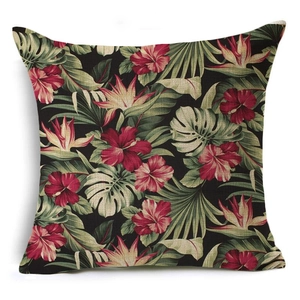 Linen cushion cover with tropical red hibiscus and green palm leaves on black background