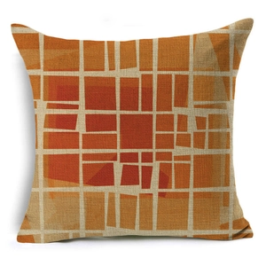Close-up of geometric linen pillow cover showing fiber texture and orange abstract pattern