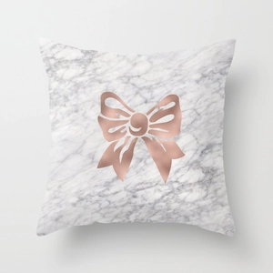 Detailed texture of marble pattern cushion cover with rose gold metallic bow print