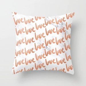 Detail of marble pattern pillowcase featuring repeated orange handwritten love text prints