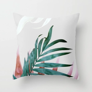 Detail of tropical palm leaf print on peach skin fabric decorative square pillow