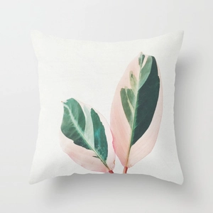 Square peach skin pillow with Calathea Triostar tropical leaf print on white base