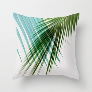 Minimalist white square throw pillow featuring artistic green tropical palm leaf patterns