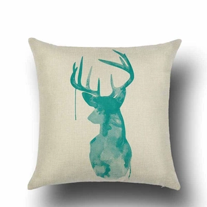 Detail of teal watercolor reindeer silhouette on linen cushion cover with textured fabric