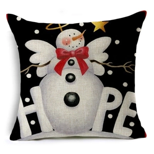 Close-up of linen pillowcase with snowman pattern and artistic HOPE text print