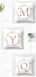 Macro shot of peach skin pillowcase showing gold floral alphabet letters and soft texture