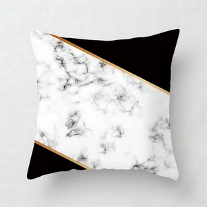 Detail of pink marble pattern pillowcase with geometric gold lines and black fabric contrast