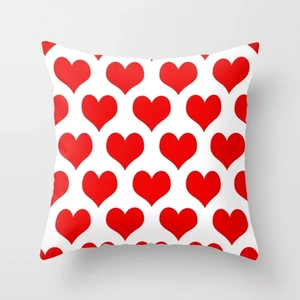Detailed view of square pillowcase with red heart pattern and fine fabric texture