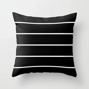 Detail of minimalist black and white striped geometric pillowcase in soft peach skin fabric