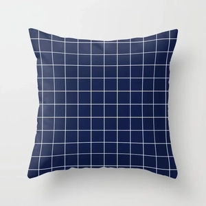 Detail of navy blue linen pillowcase featuring a white grid pattern and neat stitching