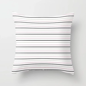 Detail view of modern geometric cushion cover featuring black, pink, and gray stripes