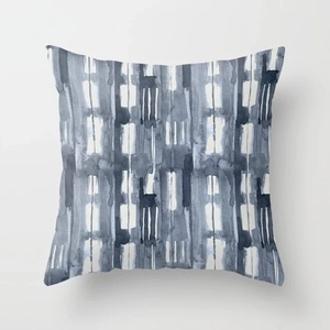Close-up of geometric watercolor patterns in navy and grey on a textured pillowcase