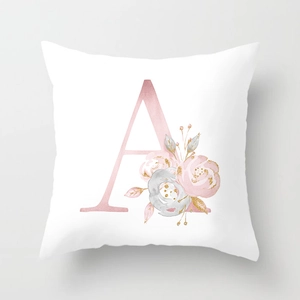Detail view of pink watercolor flowers and gold glitter accents on a white cushion cover