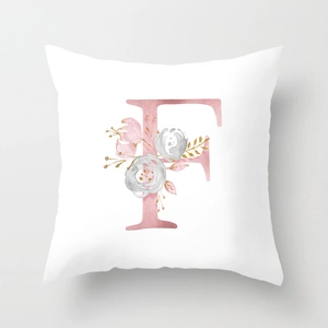 Detail of soft peach skin pillowcase with watercolor floral letter F in rose gold hues