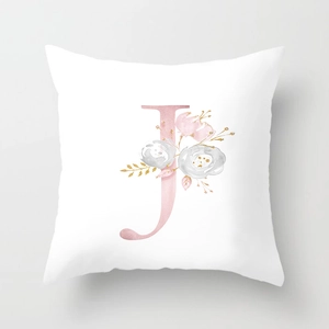 Detail of white peach skin pillowcase featuring elegant pink letter J with floral patterns
