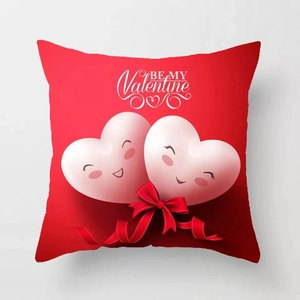 Detail of red Valentine cushion cover with two cute hearts and silk bow decoration