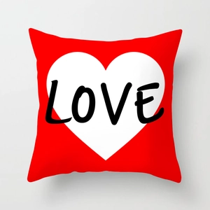 Close-up of red peach skin pillowcase with white heart and black LOVE text detail