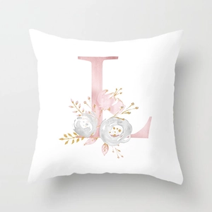 Close-up of peach skin pillowcase with watercolor floral letter L design and golden leaves