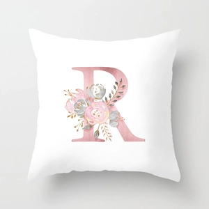 Macro detail of microfiber pillowcase featuring rose gold letter R and floral pattern