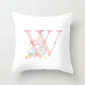 Close-up of peach skin pillowcase featuring floral letter W in watercolor style