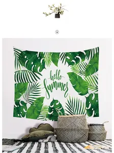 Detail of Nordic tapestry with tropical monstera leaves and Hello Summer print on white wall