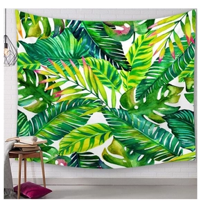 Close-up of tropical monstera leaf wall tapestry hanging on a white brick wall