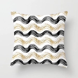 Detail of minimalist gold wavy lines and black hand-painted strokes on white cushion cover