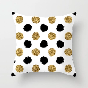 Detail of square pillowcase with hand-drawn black and metallic gold glitter polka dots