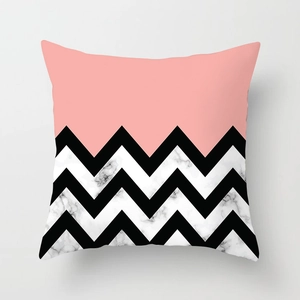 Dettaglio della federa geometrica con blocco arancio-rosa e motivo chevron marmorizzato