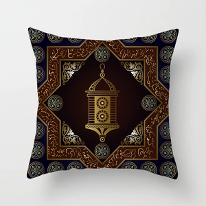 Detail of golden Ramadan lantern and Arabic calligraphy on dark blue velvet pillow cover