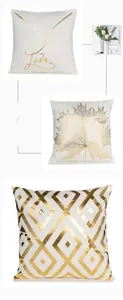 Detail of white throw pillow covers featuring gold foil leaf patterns and Love calligraphy