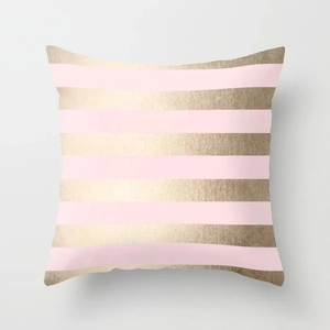 Close-up of pink marble pattern cushion cover with golden metallic stripe details