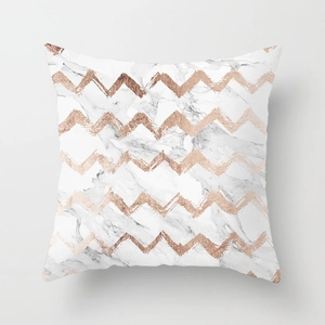 Detailed view of rose gold chevron pattern on pink marble texture cushion cover