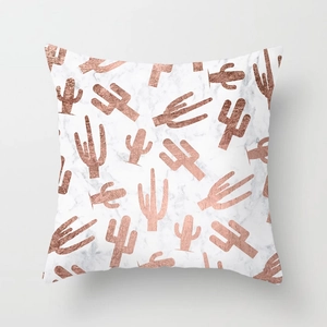 Macro detail of pink marble cushion cover with metallic rose gold cactus patterns